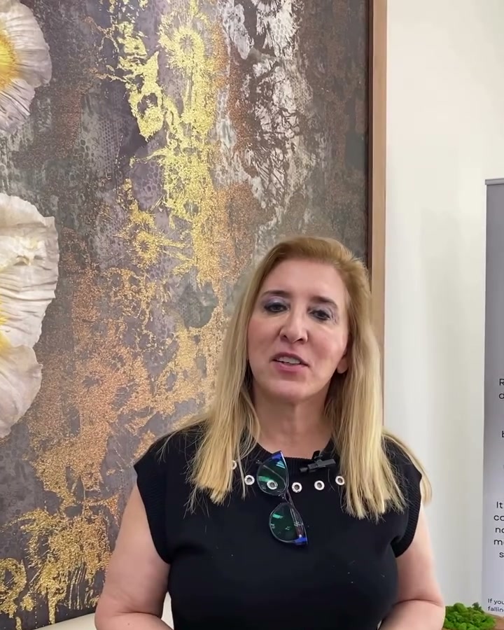 Dr. Abboud in the Qua lounge, in front of the gold floral mural